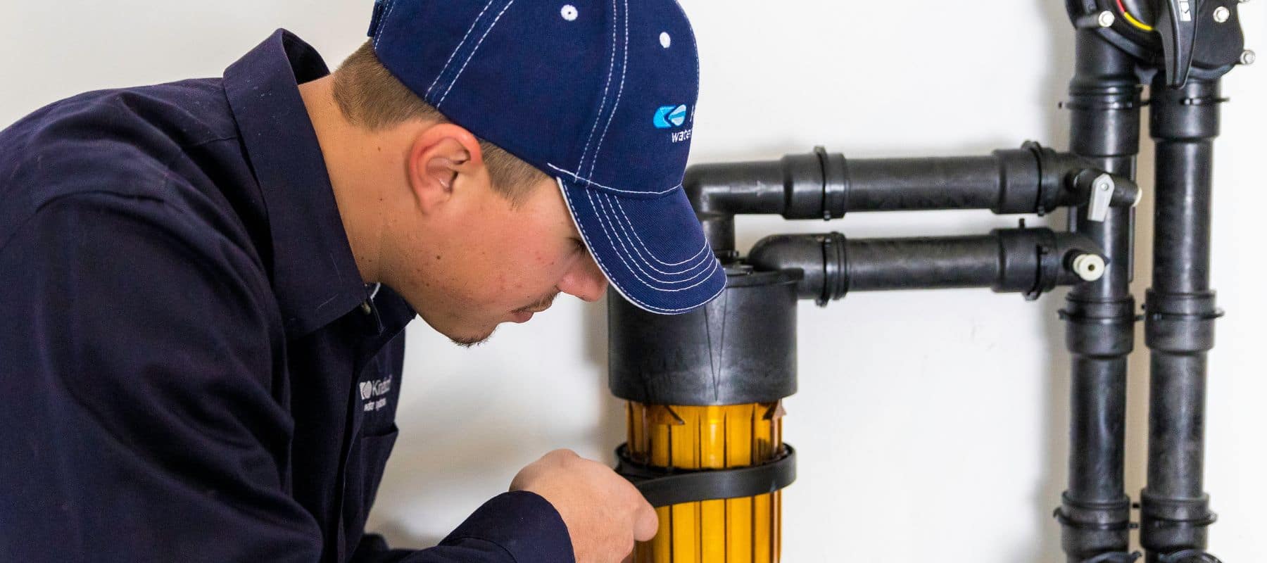 technician fixing kinetico water softener
