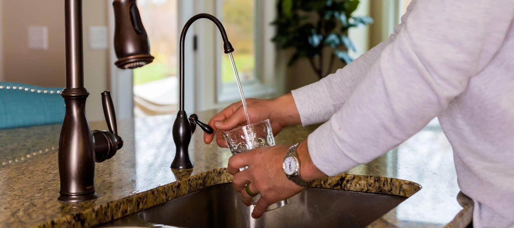 homeowner getting water from faucet