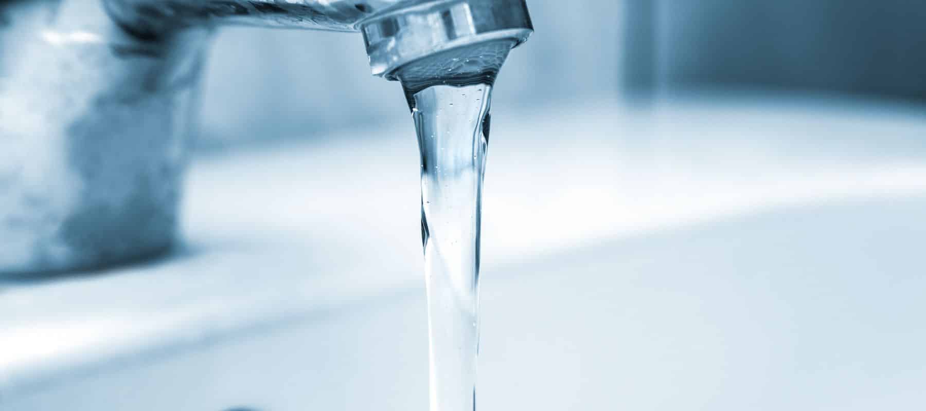 closeup of a faucet with water coming out of it