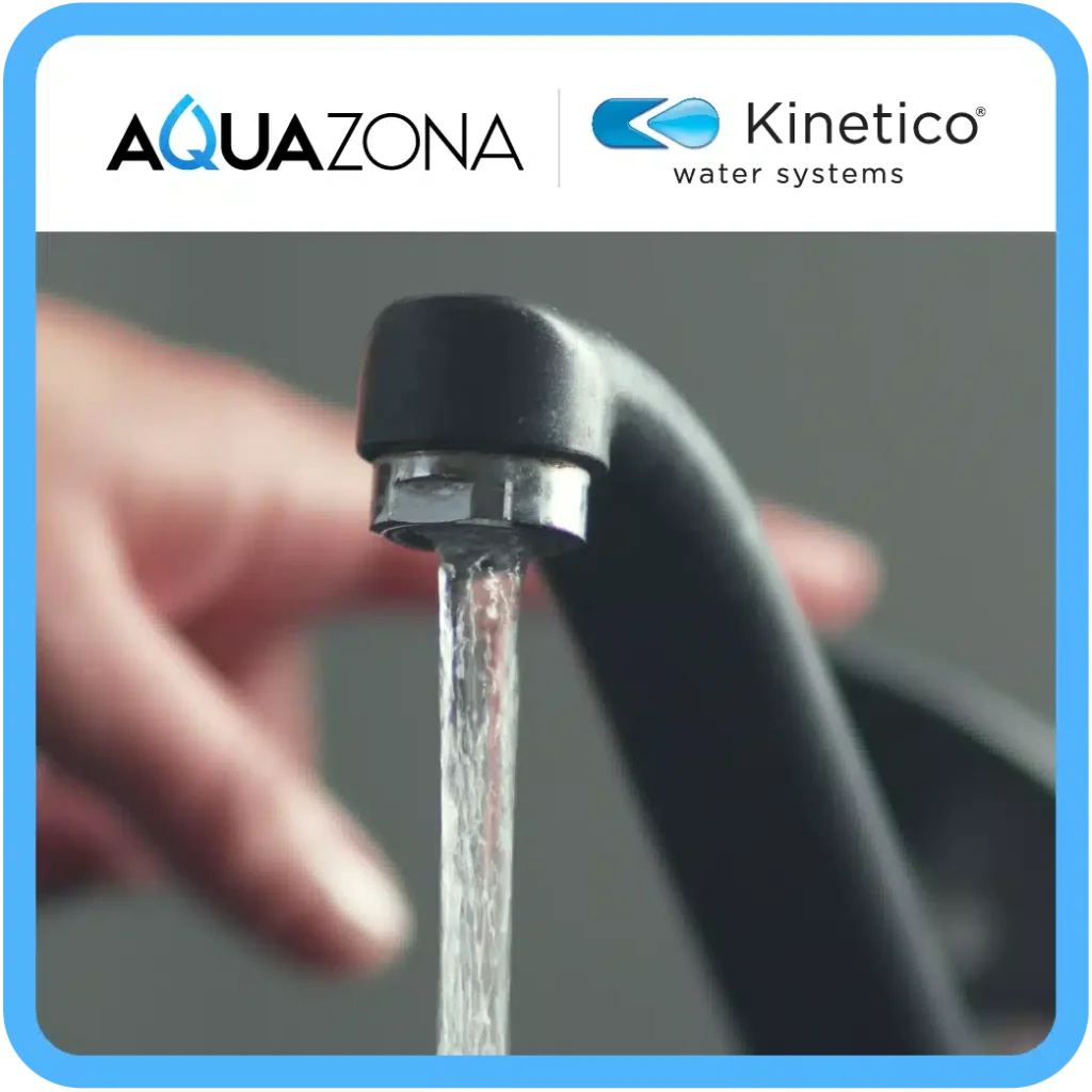 close up of filtered water coming out of black sink faucet