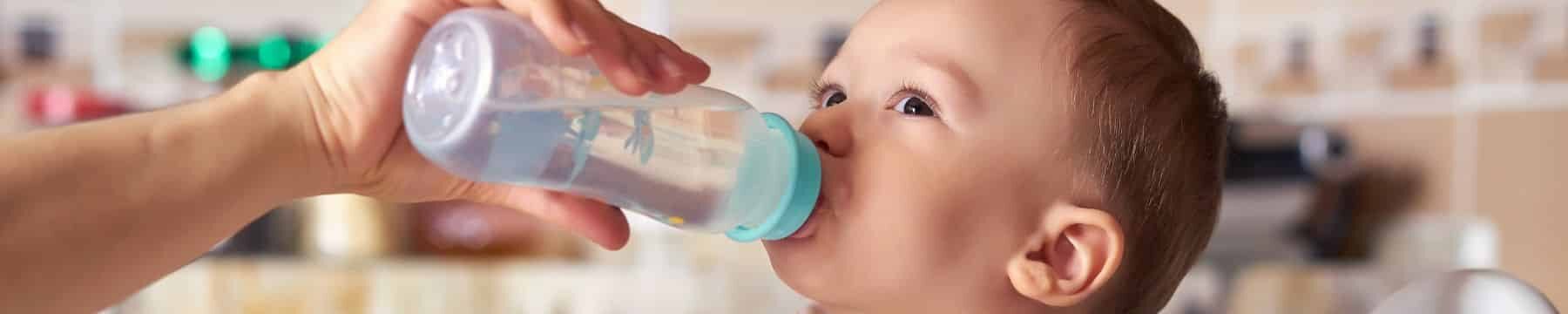baby drinking water from a bottle